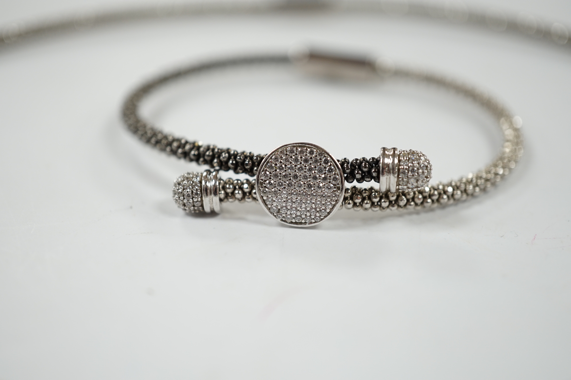 A modern Links of London, silver necklace with diamond cluster motif and a similar bracelet, in Links of London box.